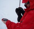 Woman practices with her beacon at a Mt. Shasta Transceiver Clinic.