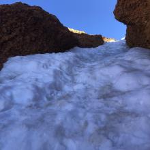 Narrow near the top of the chute.