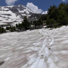 Snow on trail heading toward the springs