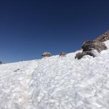 Looking up at the only snow patch on route, on the summit plateau. 