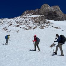 Snow on the summit plateau, with the summit pinnacle above. 