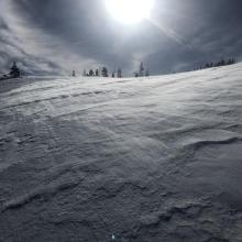 snow blowing over textured surface