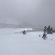 Snow blowing over ridge onto southerly slope beneath