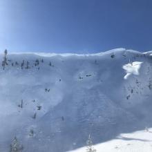 two visible crowns beneath ridge, with snow blowing over top