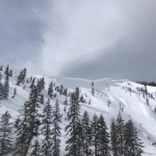 Signs of old cornice break and avalanche debris beneath ridge 