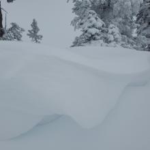 Overhanging cornices breakable upon approach.