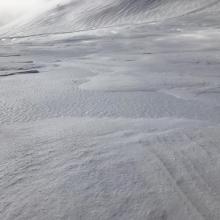 Wind textured and icy snow surface