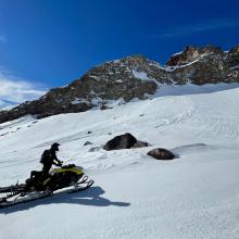 MSAC snowmobile ambassador Sean Malee under Green Butte and the old wind slab avalanche from earlier in the week