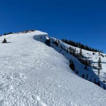 Ridgeline leading up to Middle Peak, above Heart Lake. Cornices often large along this stretch