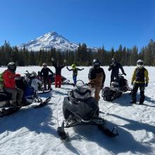The solid crew practicing avalanche beacon use and basic snowmobile handling at Jackrabbit Flat