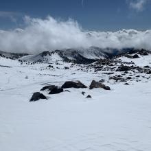 Scoured moraine tops, Gray Butte and Red Butte in the background/clouds