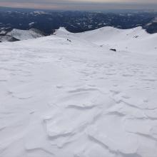 Wind pressed snow, scoured areas, sastrugi, and wind board remain at high altitudes
