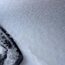 Ice glaze on snowpack near and above treeline