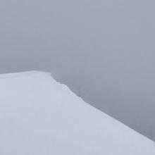 Freshly crafted wind lip with snow blowing onto east aspect near treeline